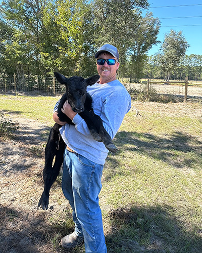 Man holding a calf.